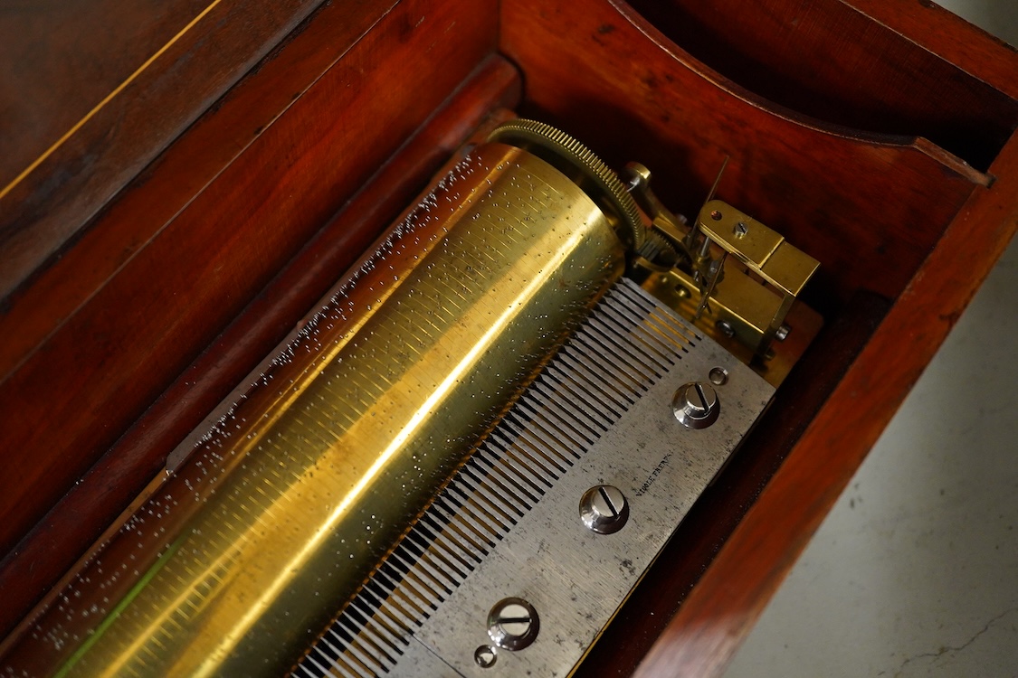 A 19th century Swiss cylinder music box by Nicole Freres, Geneve, key wound movement (with key present) playing six airs, in an inlaid rosewood case, cylinder 33cm long, the case; 52cm long, 13cm high, 17.5cm deep